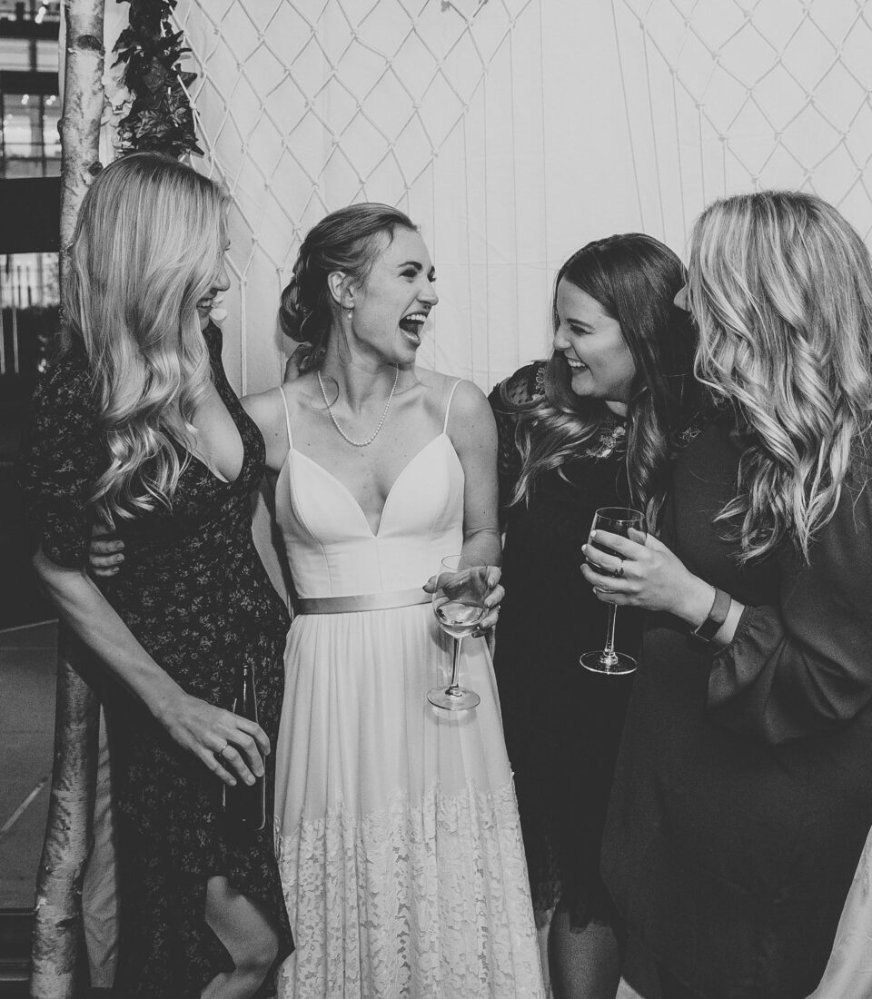 happy bride and bridal party coast weddings