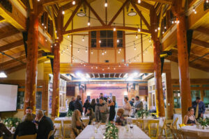 Wedding guests milling around inside Schlitz Audubon before the reception.