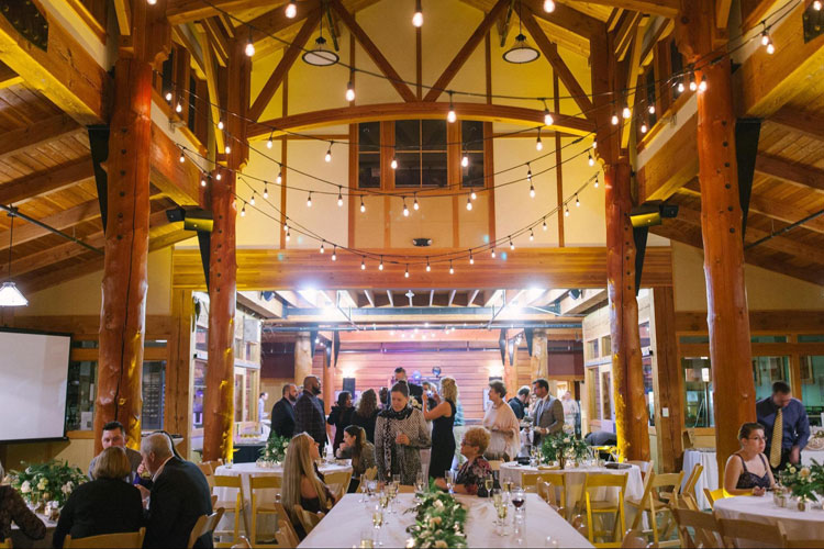 Wedding guests milling around inside Schlitz Audubon before the reception.