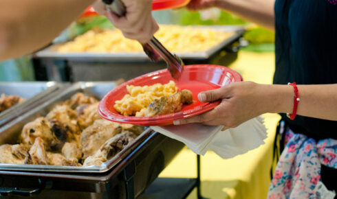 Filling plates with chicken and mac and cheese.