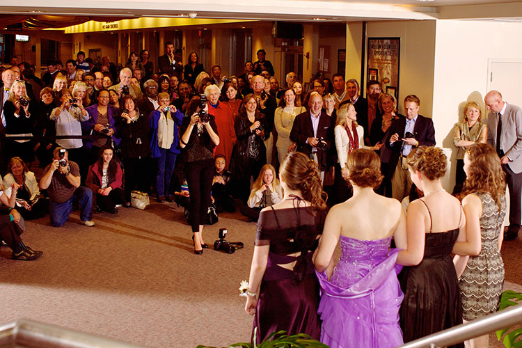 Parents taking photos of kids ready for prom