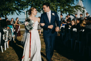 Bride and groom walking back up the isle after their ceremony.