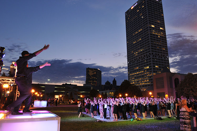 People dancing to live music at an outdoor event.