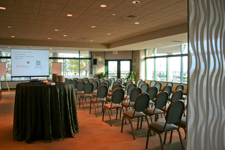 Corporate event with chairs and a screen.