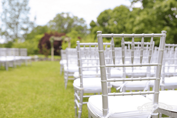 The back of a chair set up for a wedding ceremony.