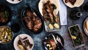 A few different meat dishes posed on a table.