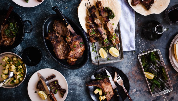 A few different meat dishes posed on a table.