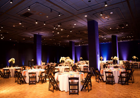 Reception set up with white linens and dark brown chairs.