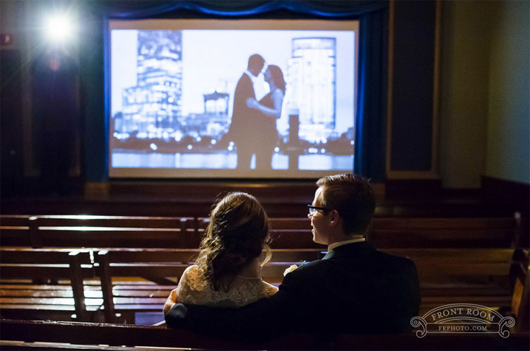 Bride and Groom in Pastime Theatre Watching Slideshow