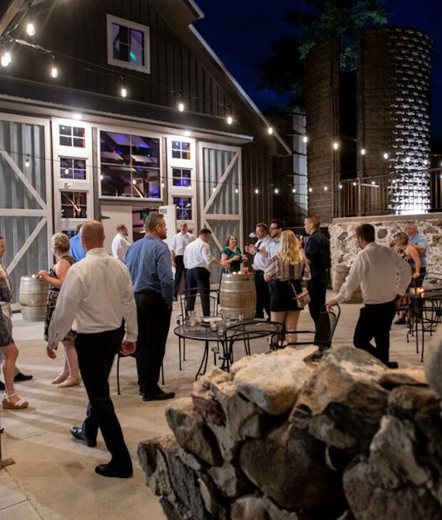Event guests on patio at night