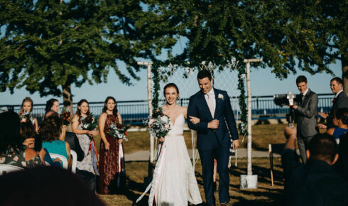 Bride and groom walking back up the isle at Zilli Lake and Gardens.