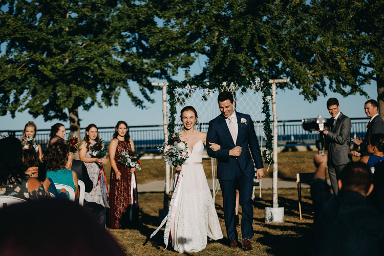 Bride and groom walking back up the isle at Zilli Lake and Gardens.