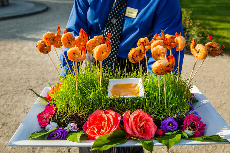 A tray of shrimp appetizers held by a Zilli staff member.