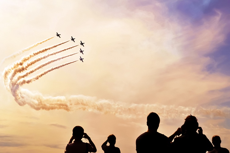 People watching a air show.