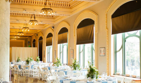 Reception tables set with white linens and powder blue napkins at Milwaukee County Historical Society.