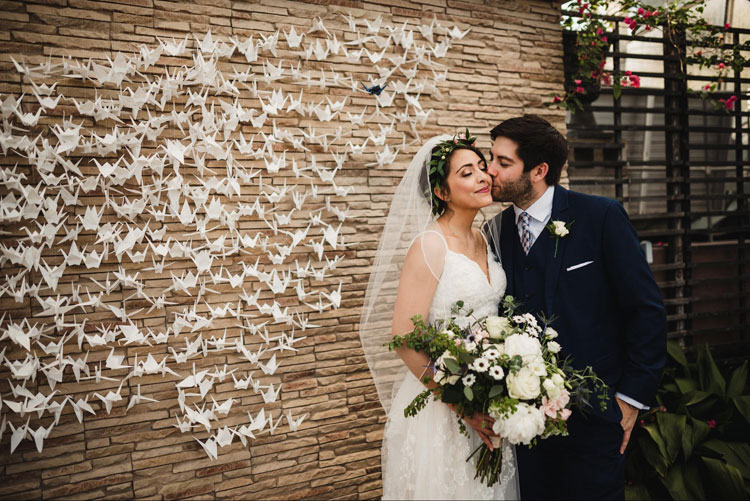 Geometric Cranes Backdrop with Bride and Groom