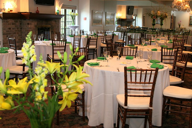 Reception tables set up with dark brown chairs and lime green napkins at Grandview Inn.