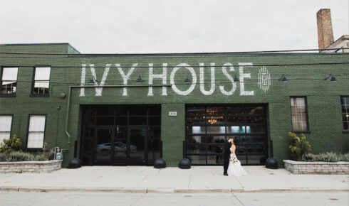 Bride and groom kissing outside of Ivy House.