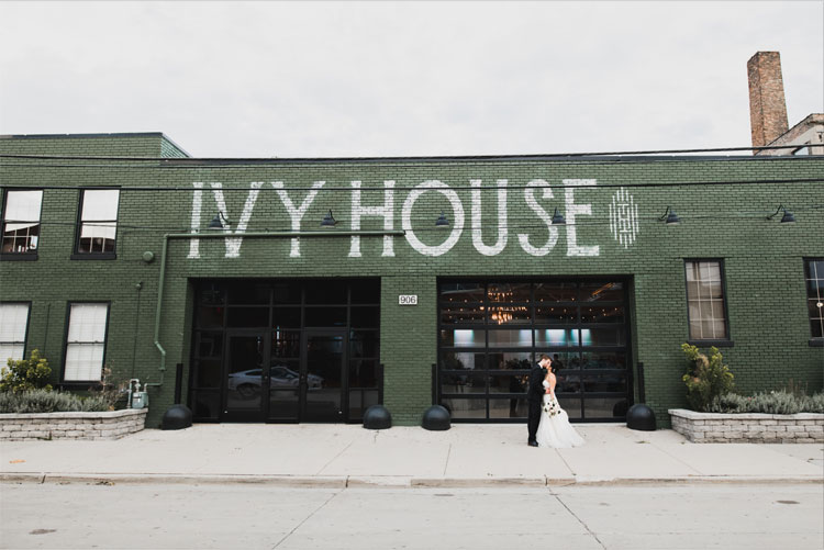 Bride and groom kissing outside of Ivy House.