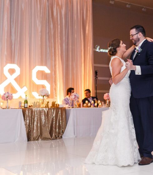 Bride and groom smiling during their first dance.