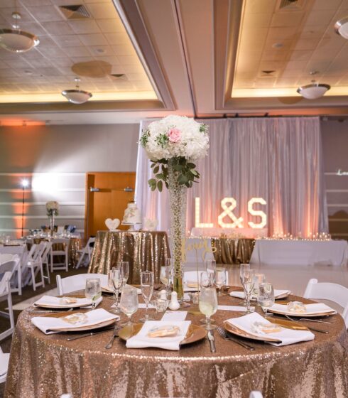 Reception tables set up with tall floral center pieces.