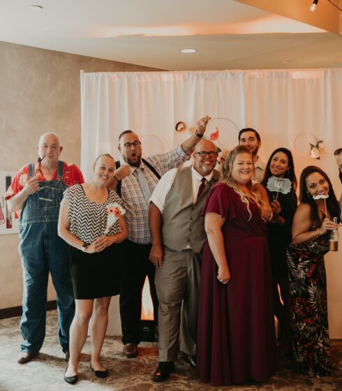 Wedding guests posing for a photo at the photobooth.