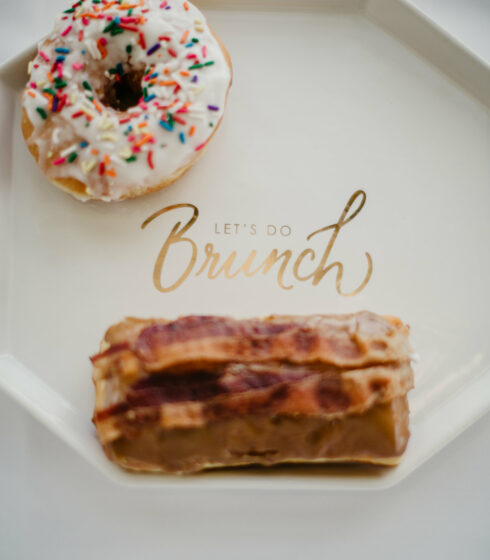 A plate that says let's do brunch with two donuts on it.