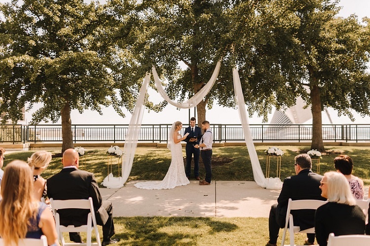 Bride and groom saying their vows at an outdoor ceremony at Zilli Lake and Gardens.