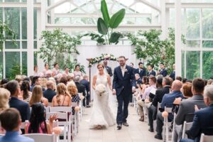 A bride and groom walking back up the isle after getting married.
