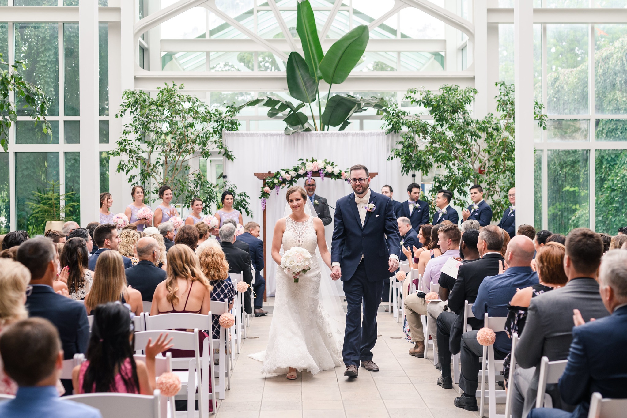 A bride and groom walking back up the isle after getting married.