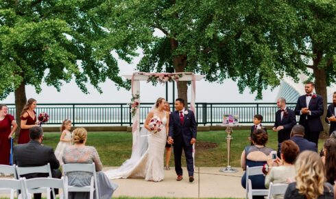 A bride and groom walking back up the isle after getting married.