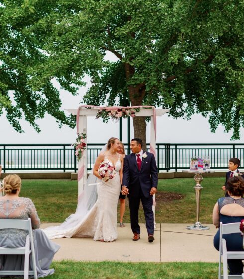 A bride and groom walking back up the isle after getting married.