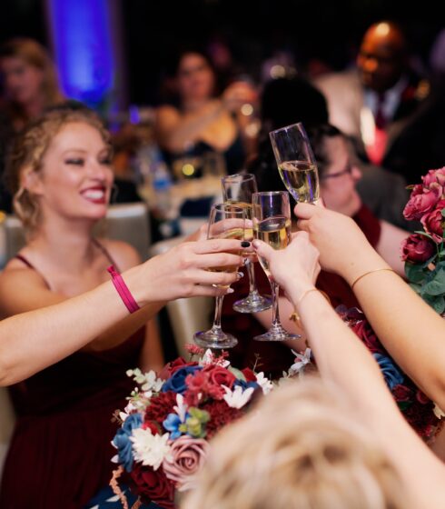 Bridesmaids toasting with champagne at a wedding reception.