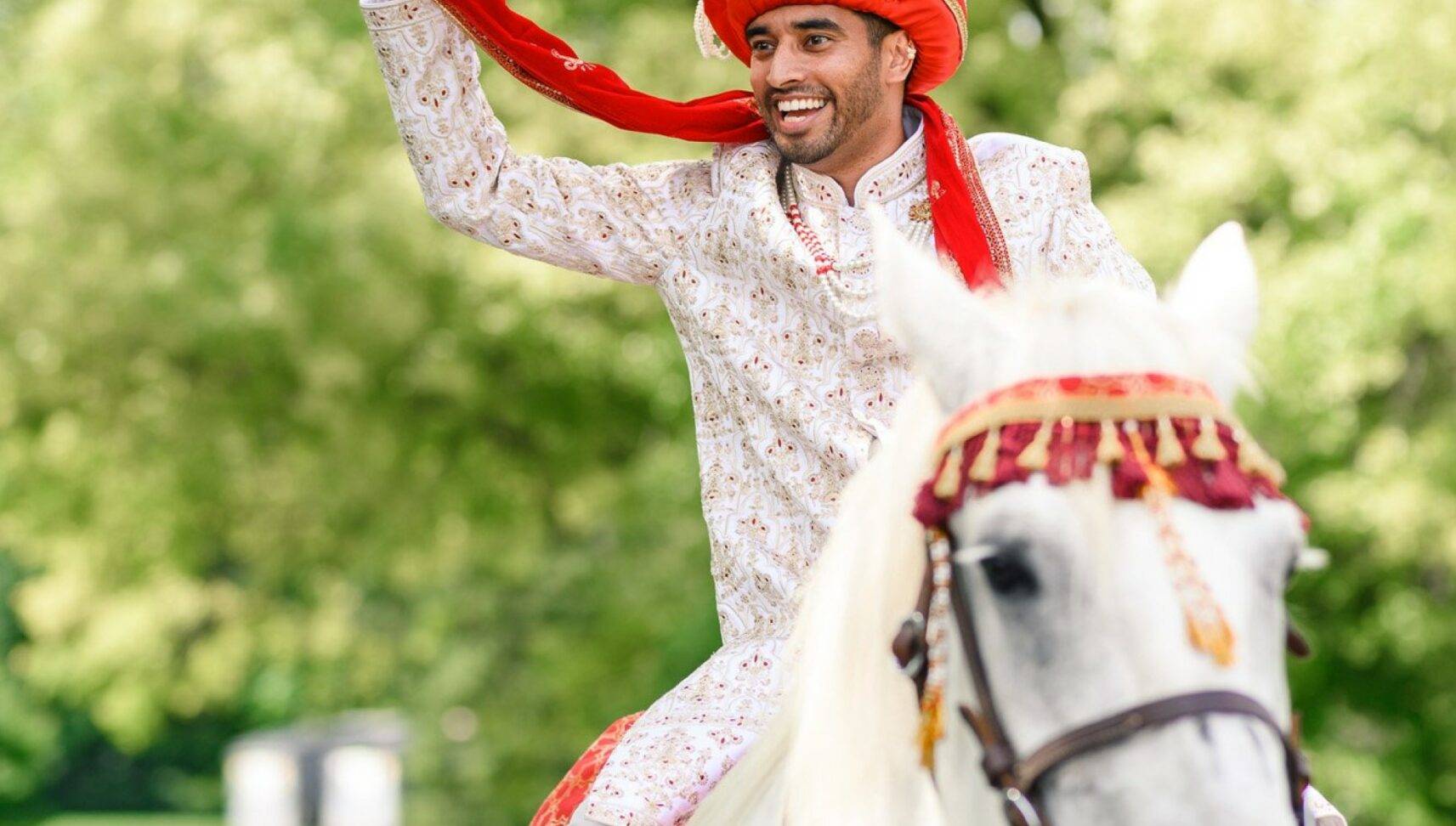 groom riding into ceremony on horse