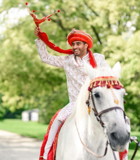 groom riding into ceremony on horse