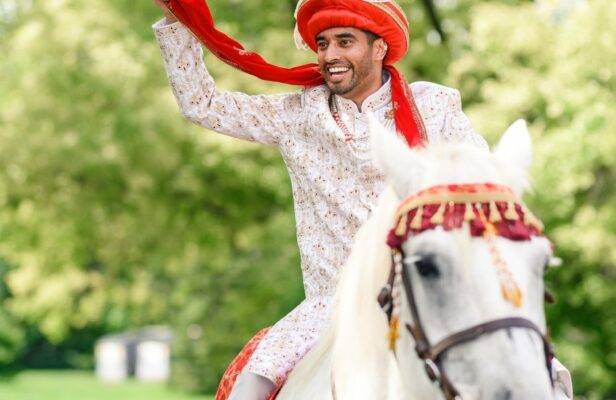 groom riding into ceremony on horse