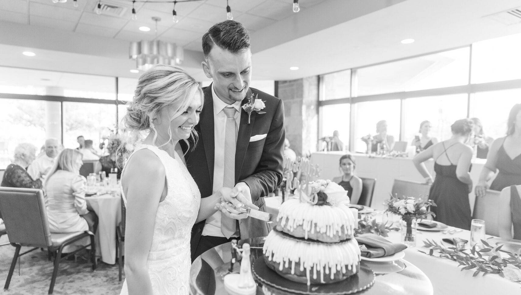 wedding couple cutting their Bundt wedding cake