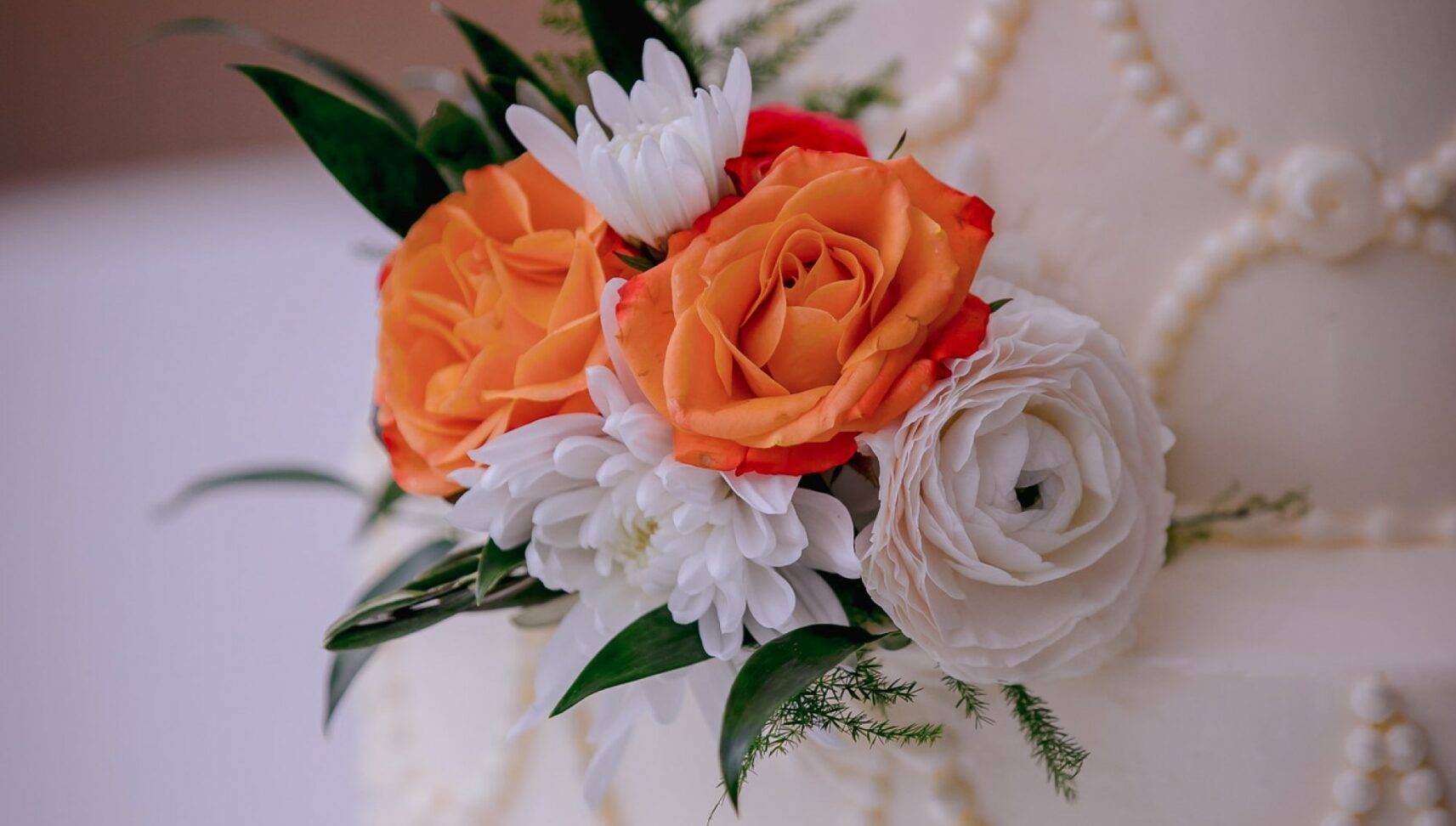 wedding cake with orange and white flowers