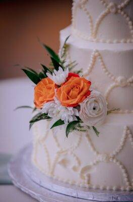 wedding cake with orange and white flowers