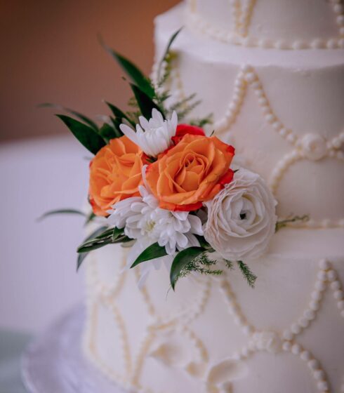 wedding cake with orange and white flowers