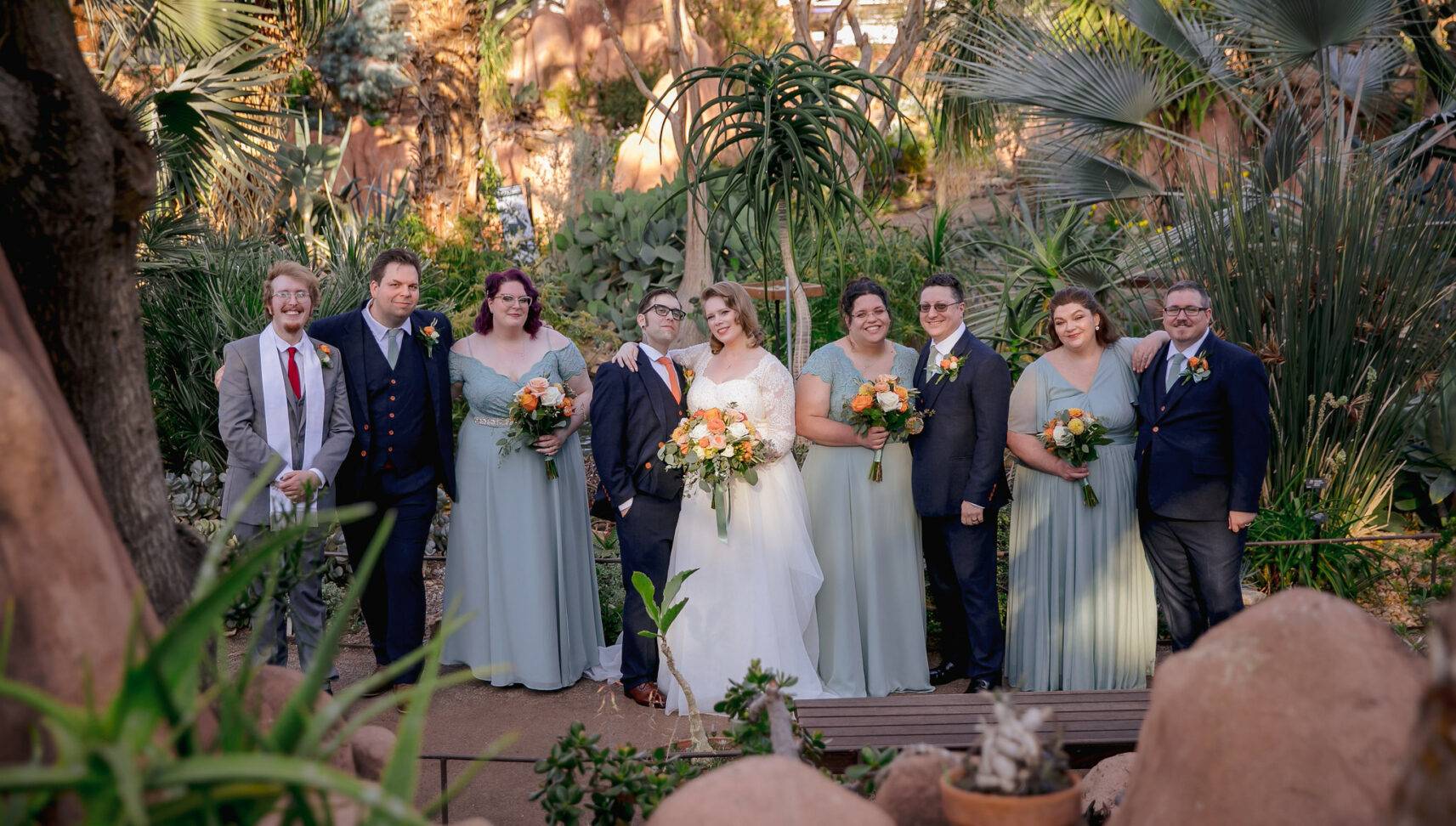 wedding party in front of greenery