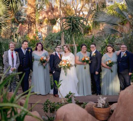 wedding party in front of greenery