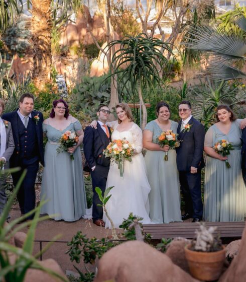 wedding party in front of greenery