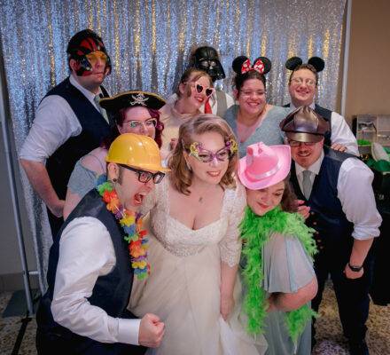 group photo with a photo booth at a wedding