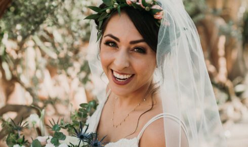 Bride smiling under the trees at Mitchell Park Domes