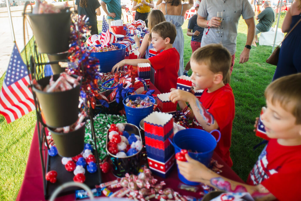 kids grabbing candy from display