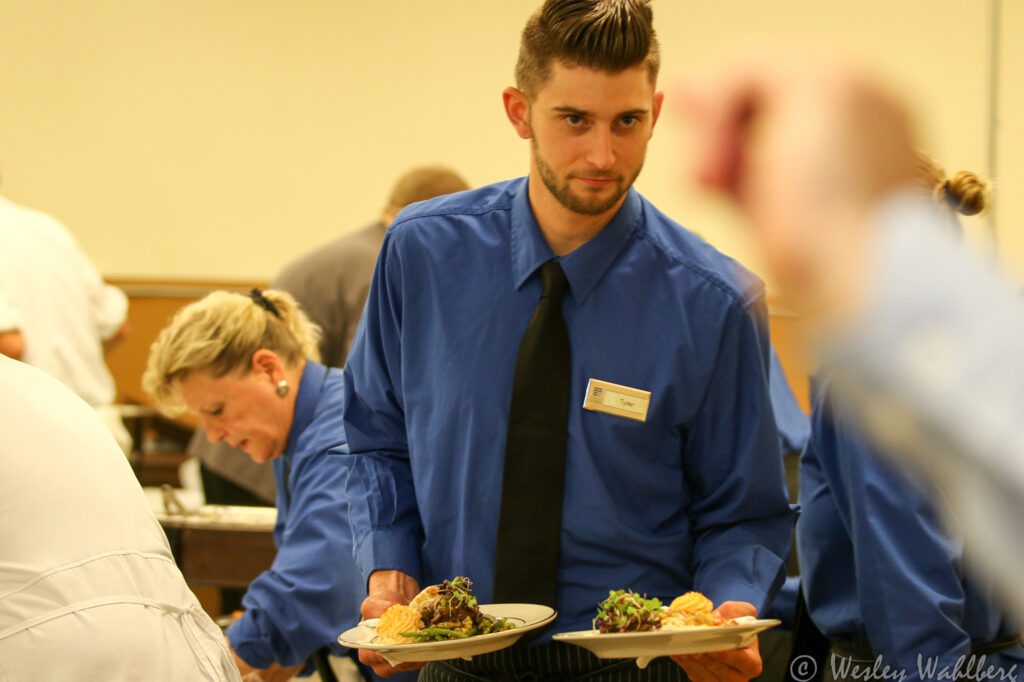staff carrying food plates
