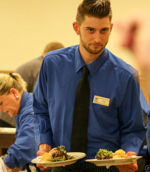 staff carrying food plates