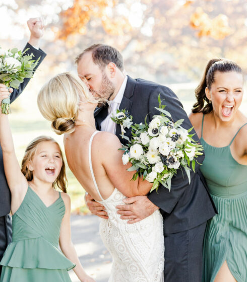 Couple in surrounded by bridal party.