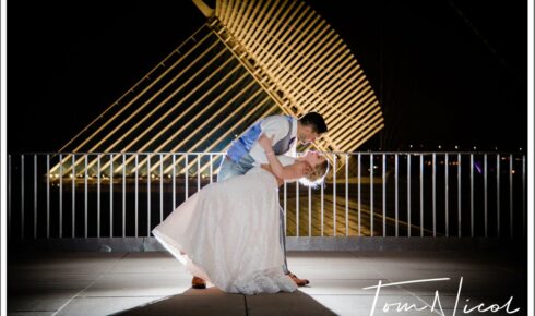 couple dipping to a kiss outside at night